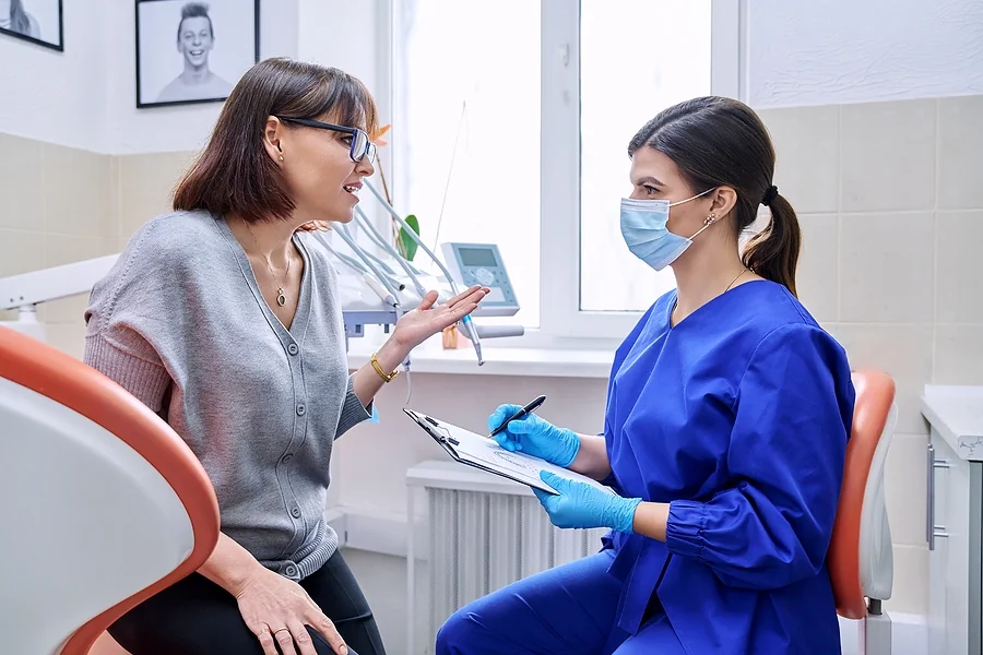 patient talking to dentist in the office
